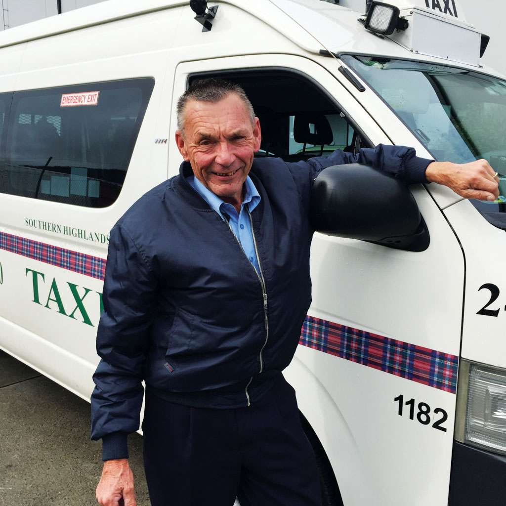 a man standing next to a white van