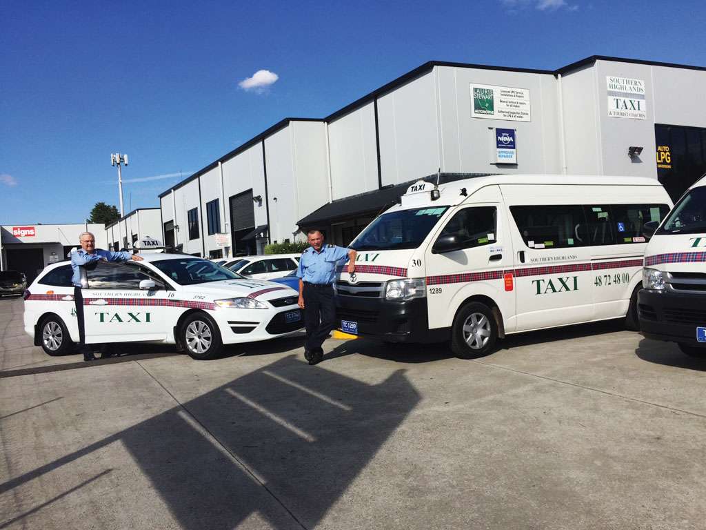 a man standing next to a taxi van