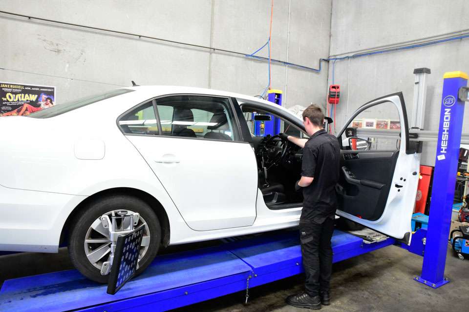 a man standing next to a car