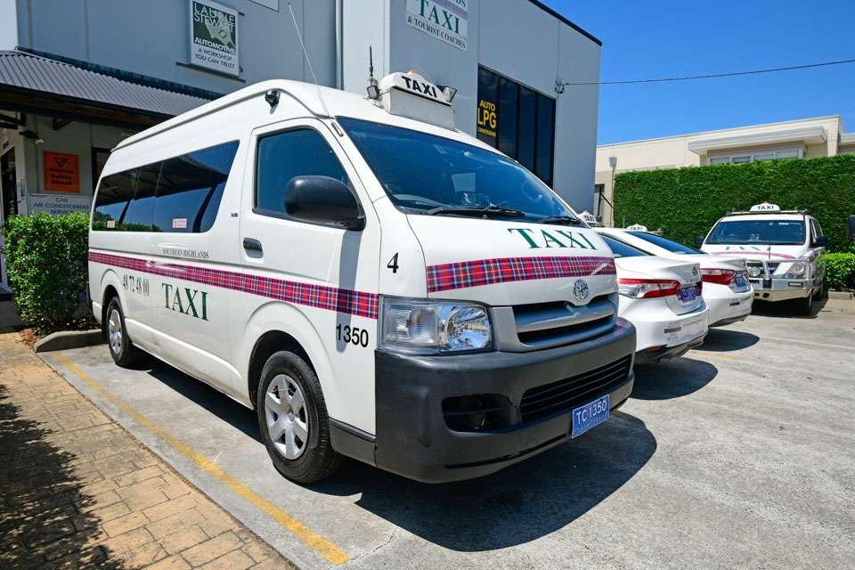 a white van parked in front of a building