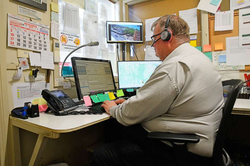 a man sitting at a desk with a computer and headphones