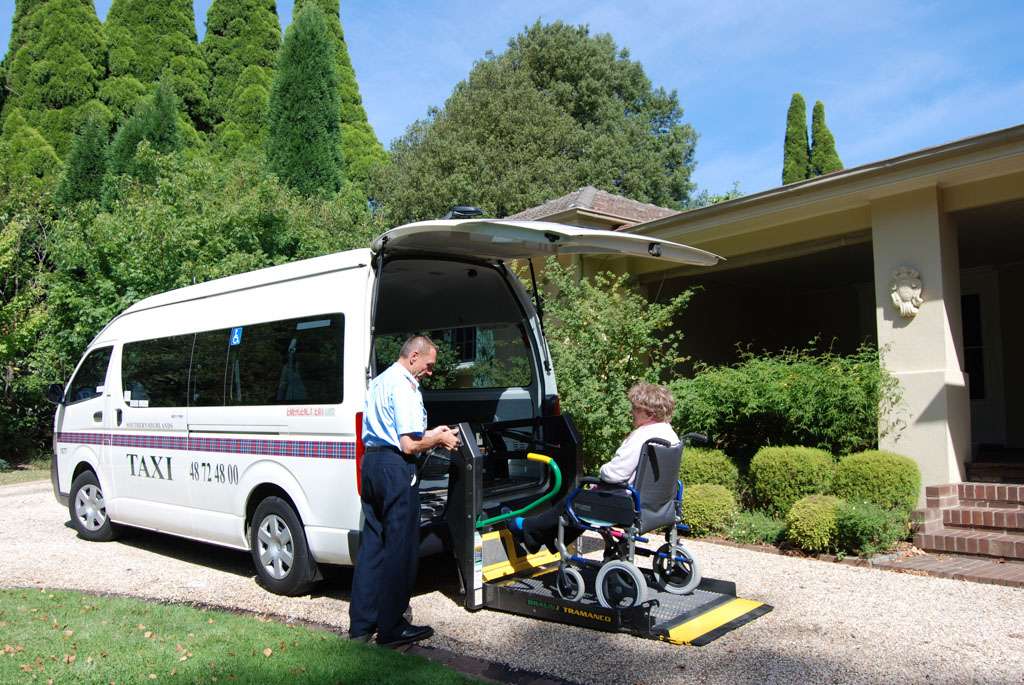 a man helping a woman in a wheelchair