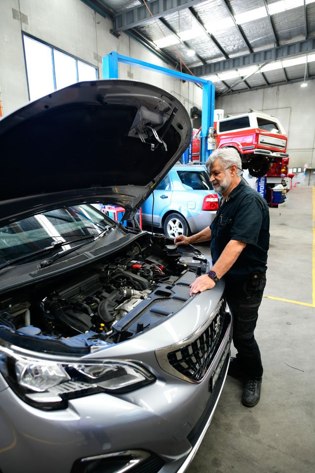 mechanic servicing car